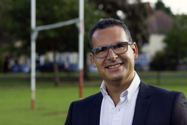Male in suit standing in rugby pitch